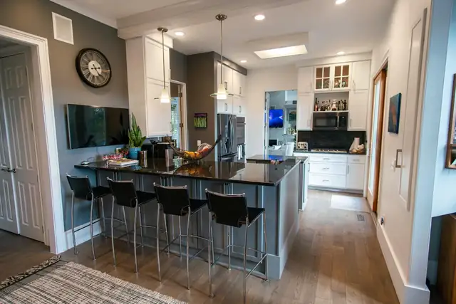 Kitchen refaced in Shaker style doors in Fashion Grey and White Satin with a dark island and bar stools